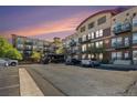 Apartment building exterior at sunset with brick accents and balconies at 10184 Park Meadows Dr # 1102, Lone Tree, CO 80124