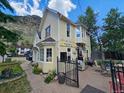 Charming yellow commercial building with outdoor seating and clear mountain views at 710 6Th St, Georgetown, CO 80444