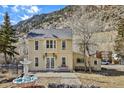 Inviting yellow two-story commercial building set against a mountain backdrop at 710 6Th St, Georgetown, CO 80444