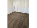 Cozy room featuring neutral carpet, white walls, closet, and white door at 1125 S Eaton Ct, Lakewood, CO 80232