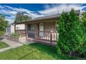 Charming home with a well-manicured lawn and inviting front porch, perfect for relaxing outdoors at 3090 W Longfellow Pl, Denver, CO 80221