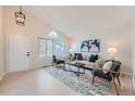 Inviting living room with vaulted ceilings, a large window, and stylish decor at 9383 Cobblecrest Dr, Highlands Ranch, CO 80126