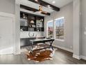 Stylish home office featuring custom built-ins, beamed ceiling, and natural light at 5755 Boston St, Denver, CO 80238