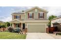 Inviting two-story home boasts a two-car garage, red shutters, and a well-maintained front yard at 6385 S Nelson Way, Littleton, CO 80127