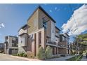 Contemporary townhome showcasing a stylish exterior with multiple balconies and modern architectural details at 3795 Depew St # D, Wheat Ridge, CO 80212