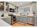 Updated kitchen with light blue cabinets, stainless steel appliances and hardwood floors at 10395 Red Mountain E, Littleton, CO 80127