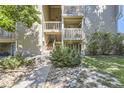 Charming condo exterior featuring stairs to unit entrance, maintained landscaping, and rock features at 4068 S Atchison Way # 101, Aurora, CO 80014