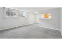 Spacious, carpeted living room featuring natural light and a pass-through to the kitchen at 9220 E Girard Ave # 2, Denver, CO 80231