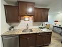 Updated kitchen boasts granite countertops, stainless steel dishwasher, undermount lighting and modern faucet at 2325 S Linden Ct # 211, Denver, CO 80222