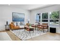 Bright living room featuring a comfy leather sofa and large windows at 5576 E Lehigh Ave, Denver, CO 80237