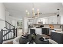 Modern kitchen featuring stainless appliances, island with white countertop and an adjacent dining area at 5068 E Crestone Ave, Castle Rock, CO 80104