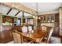 A spacious dining room with wood floors, stone archway, and natural light at 2480 Castle Butte Dr, Castle Rock, CO 80109