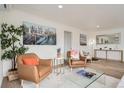 Comfortable living room featuring hardwood floors, modern décor, and abundant natural light at 3780 Benton St, Wheat Ridge, CO 80212