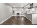 Open-concept living area features a fireplace and connects seamlessly with the modern kitchen at 748 W 100Th Ave, Northglenn, CO 80260