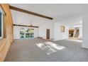 Bright living room with a vaulted ceiling, wood accents, a sliding glass door to the deck, and a staircase at 9212 Tanglewood Rd, Franktown, CO 80116