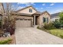 Inviting home exterior with a stone facade, two-car garage and well-maintained front yard at 22310 E Chenango Dr, Aurora, CO 80015