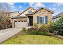 Charming home with stone facade, complemented by a well-maintained front yard and two-car garage at 22310 E Chenango Dr, Aurora, CO 80015