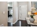 Elegant foyer boasting dark hardwood floors, white trim, and a stylish entryway at 22310 E Chenango Dr, Aurora, CO 80015