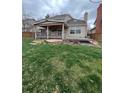 Expansive backyard showcasing a covered patio, offering an ideal space for outdoor relaxation and entertainment. Mature landscaping present at 5151 S Laredo Ct, Centennial, CO 80015