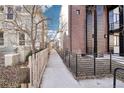 Side of townhome showing a sidewalk and fence, offering a glimpse of the home's exterior at 25 S Washington St # 2, Denver, CO 80209