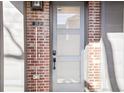 Front door with glass panels, a digital lock, and brick accents at 25 S Washington St # 2, Denver, CO 80209