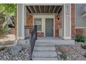 Inviting front entrance with a well-lit porch and concrete steps at 9520 Halstead, Lone Tree, CO 80124