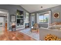 Cozy living room with hardwood floors, a fireplace, built-in shelving, and a sliding glass door at 8481 W Union Ave # 13203, Denver, CO 80123