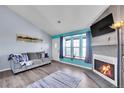 Bright living room with a modern fireplace, large windows, and cozy furnishings at 17478 E Rice Cir # D, Aurora, CO 80015