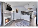 Open-concept living space with a fireplace, adjacent kitchen, and modern decor at 17478 E Rice Cir # D, Aurora, CO 80015