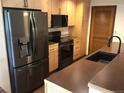 Kitchen with wooden cabinets and stainless steel appliances including a refrigerator, oven, and microwave at 9088 W 88Th Cir, Westminster, CO 80021