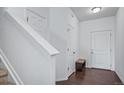 Inviting entryway featuring pristine white walls, hardwood floors, and a staircase leading to the upper level at 18039 E 108Th Pl, Commerce City, CO 80022