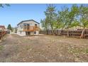 Spacious backyard with a wooden fence and second story deck at 825 S Quitman St, Denver, CO 80219