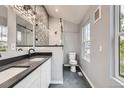 Modern bathroom with dual sinks, sleek fixtures, and stylish tiling at 825 S Quitman St, Denver, CO 80219