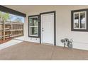 Close-up of the exterior door with storm door and modern black trim at 825 S Quitman St, Denver, CO 80219