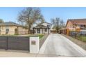 Charming home exterior featuring a long driveway and well-maintained landscaping at 825 S Quitman St, Denver, CO 80219