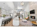 Bright, open-concept living room boasts high ceilings, fireplace, and staircase to the second floor at 9340 Mount Jackson St, Littleton, CO 80125