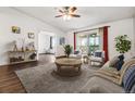 Inviting living room with wood floors and a sliding glass door to the balcony at 795 S Alton Way # 5D, Denver, CO 80247