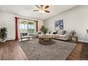 A bright living room with a balcony, wooden table, and light gray carpet at 795 S Alton Way # 5D, Denver, CO 80247