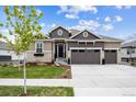 Inviting home with manicured lawn, three-car garage, and charming architectural details at 8890 S Quatar Ct, Aurora, CO 80016