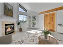 Cozy living room showcasing fireplace, large windows, and wood accents, creating a warm ambiance at 31819 Rocky Village Dr # 418, Evergreen, CO 80439