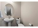 Cozy powder room with pedestal sink and neutral wall color at 1330 Independence St # 2, Lakewood, CO 80215
