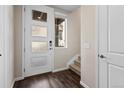 Bright entryway with stylish front door, hardwood floors, and staircase access at 1330 Independence St # 2, Lakewood, CO 80215