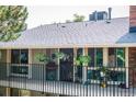 A charming balcony with black iron railings is adorned with an array of colorful flowers and plants at 6495 E Happy Canyon Rd # 163, Denver, CO 80237