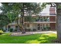 Well-maintained townhouse with a manicured lawn and mature trees offering shade and curb appeal at 6495 E Happy Canyon Rd # 163, Denver, CO 80237