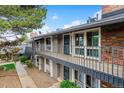 Two-story townhome featuring a balcony and well-maintained landscaping at 6495 E Happy Canyon Rd # 163, Denver, CO 80237