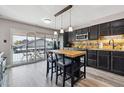 Bright eat-in kitchen features an island with barstool seating and a sliding door to the balcony at 6495 E Happy Canyon Rd # 163, Denver, CO 80237