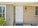 Welcoming entryway featuring a white door with glass inserts and a brick facade with visible house number at 2243 S Olive St, Denver, CO 80224