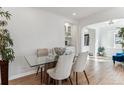 Elegant dining room showcasing a glass-top table, plush chairs, and open access to adjacent rooms at 2626 S Pennsylvania St, Denver, CO 80210