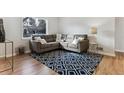 Cozy living room with a large window, comfortable seating and a modern patterned rug at 2626 S Pennsylvania St, Denver, CO 80210