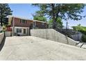 Brick home with a concrete patio and landscaped yard, offering outdoor space and curb appeal at 25 S Winona Ct, Denver, CO 80219